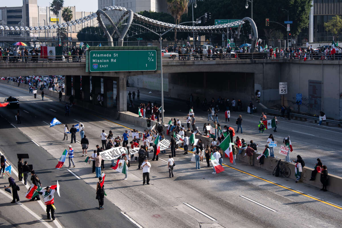 Protestors block lanes on the 101 Freeway during a rally in support of immigrants in response to the Trump administration's new policies on February 2, 2025, in Los Angeles, California.
