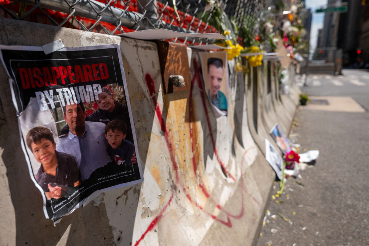 Pictures of those arrested by federal agents are displayed along a fence with flowers outside of the federal building in Manhattan housing immigration courts on July 18, 2025, in New York City.