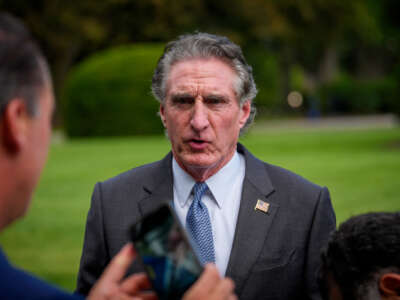U.S. Interior Secretary Doug Burgum walks to a television interview on the North Lawn of the White House on August 12, 2025, in Washington, D.C.