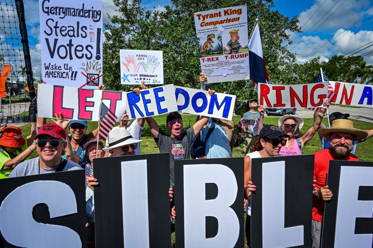 People take part in a "Fight the Trump Takeover" rally, part of a national day of action, in Wilton Manors, Florida, on August 16, 2025. The national day of action was planned after weeks of maneuvering in Texas, where Gov. Greg Abbott -- acting at Donald Trump's behest -- is trying to redraw electoral districts to benefit his Republican Party.