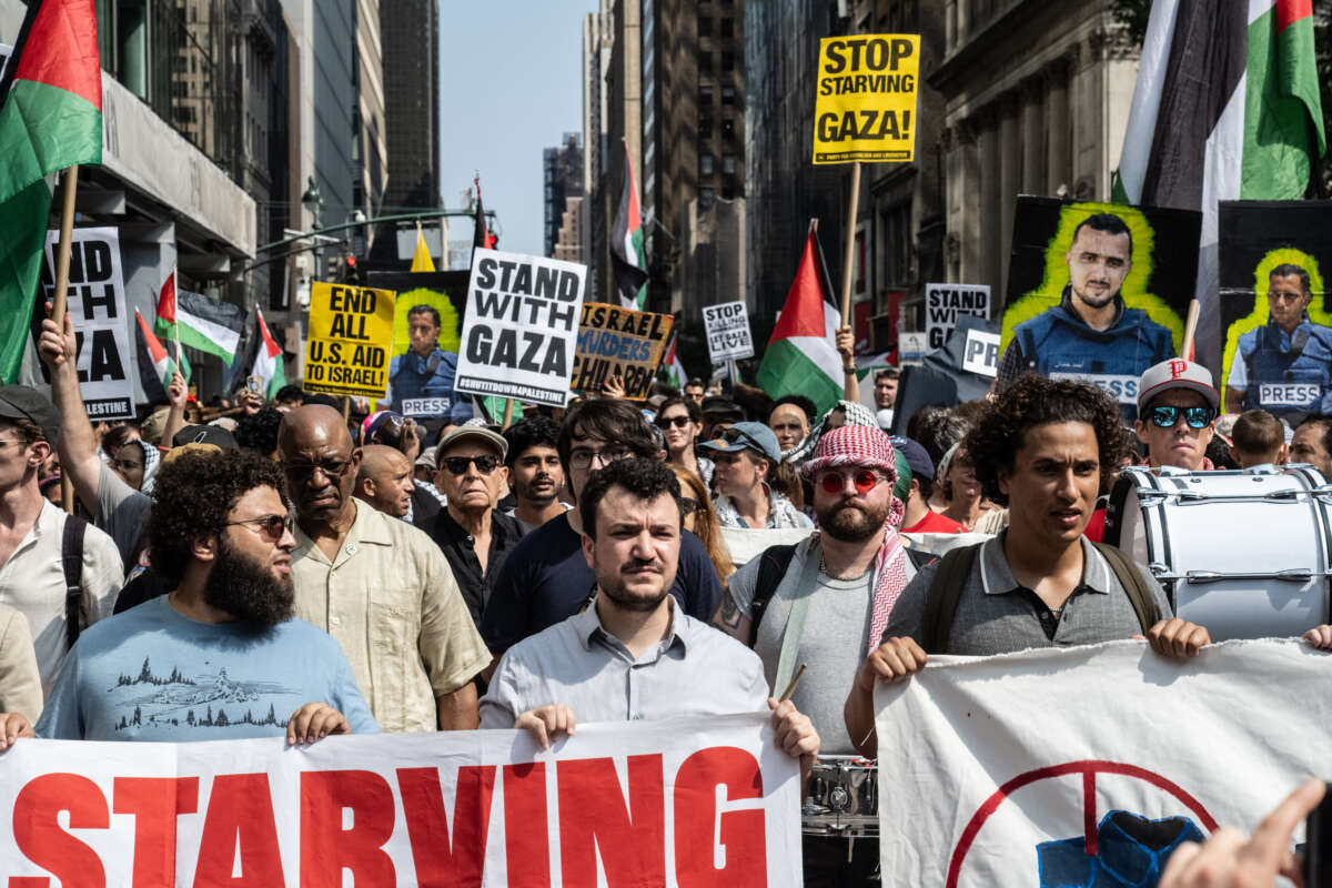 A group of protesters led by Mahmoud Khalil hold signs that read "stand with Gaza" in New York City