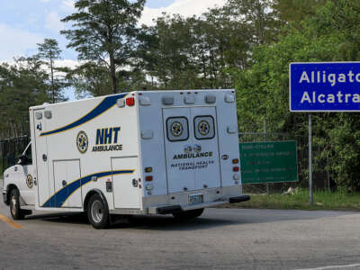 An ambulance arrives at the entrance to "Alligator Alcatraz"