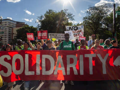 Activists gather at Dupont Circle for a rally and march, marking Labor Day with a demonstration against a federal law enforcement surge in the nation's capital.