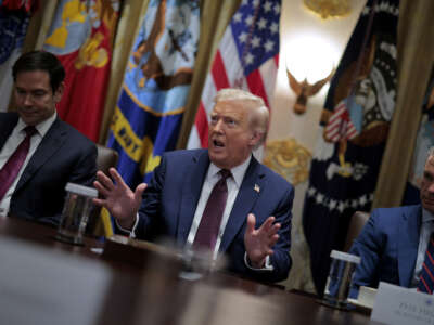 Secretary of State Marco Rubio (L) and Defense Secretary Pete Hegseth listen to U.S. President Donald Trump speak a cabinet meeting with members of his administration in the Cabinet Room of the White House on August 26, 2025, in Washington, D.C.