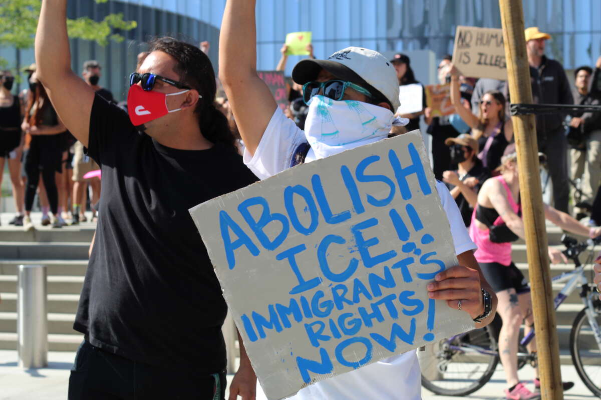 A group of anti-ICE demonstrators stands outside of Long Beach City Hall, on June 10, 2025.