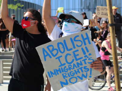A group of anti-ICE demonstrators stands outside of Long Beach City Hall, on June 10, 2025.
