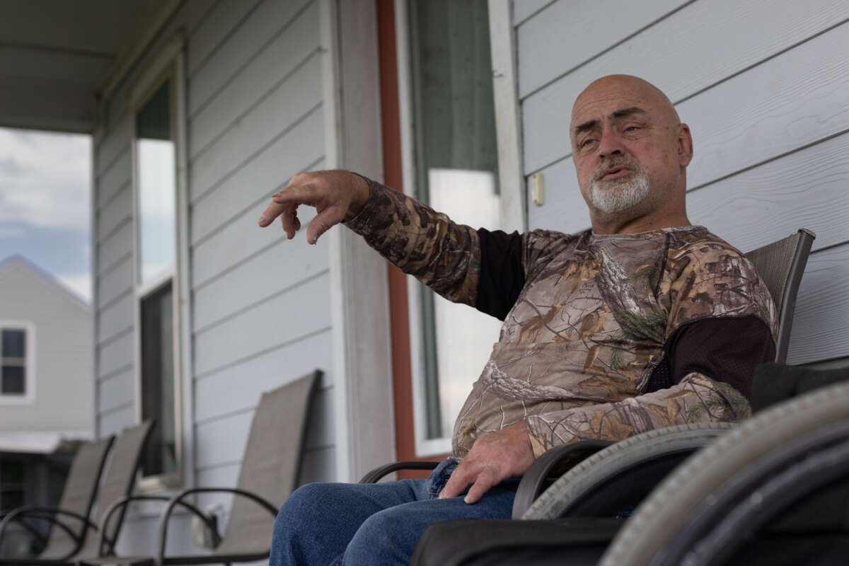 “I never expected that relocation was going to happen in my lifetime. Now that I see that it has happened, it’s not a celebration,” says Chris Brunet, pictured here in front of his house in the Louisiana Isle De Jean Charles resettlement, known as “The New Isle.” Brunet was one of the 37 people or families in the first fully federally-funded relocation project in the country. 