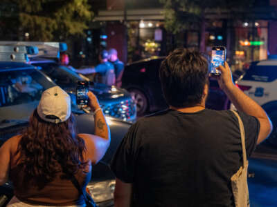 Residents record a Metropolitan Police officer in Washington, D.C.