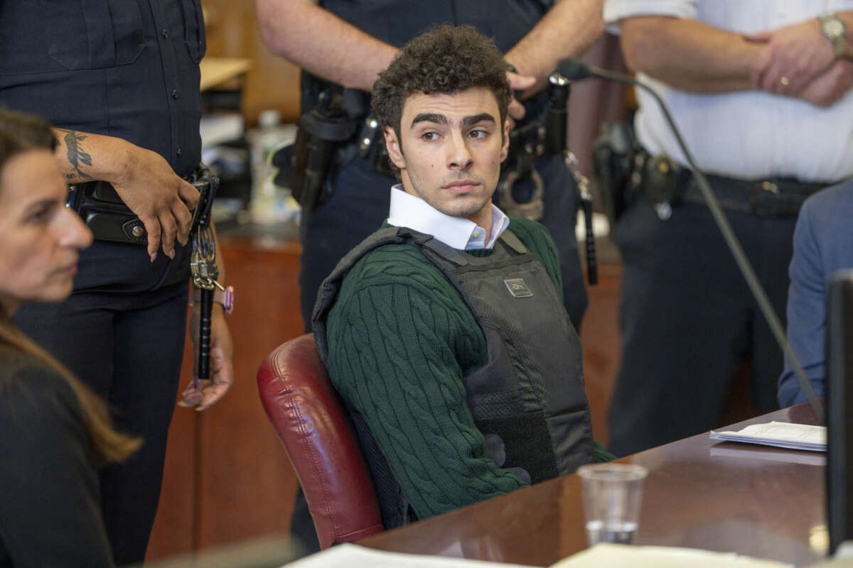 Luigi Mangione sits next to his attorney in Manhattan Supreme Court.