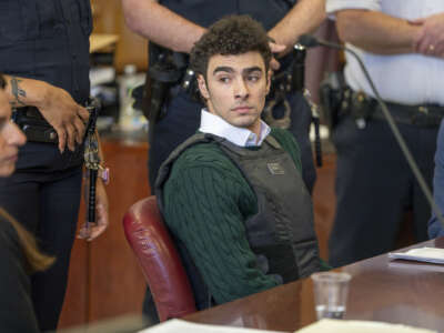 Luigi Mangione sits next to his attorney in Manhattan Supreme Court.