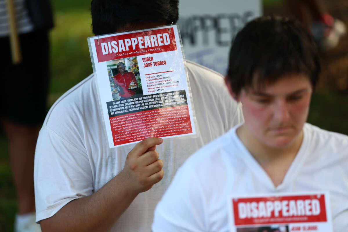 People reenact detentions at Centro de Confinamiento del Terrorismo (CECOT) during the "Good Trouble Lives On" rally and protest march in Washington, D.C.