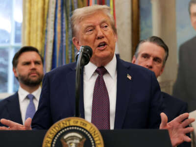 President Donald Trump speaks to the media in the Oval Office at the White House.