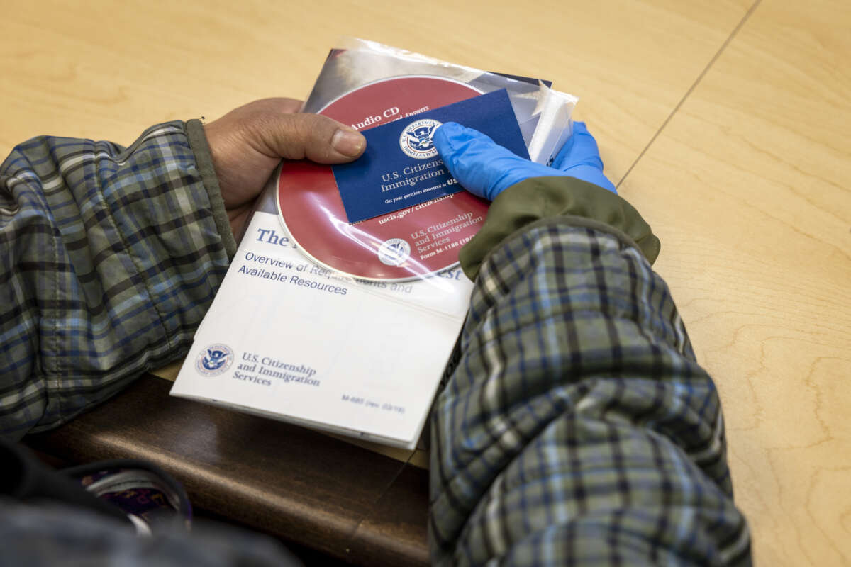 An immigrant from the Philippines listens at an informational session given by U.S. Citizenship and Immigration Services (USCIS.)