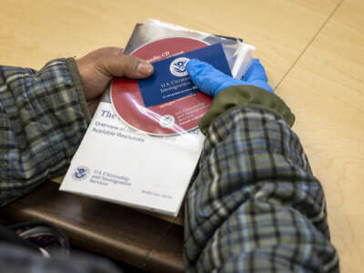 An immigrant from the Philippines listens at an informational session given by U.S. Citizenship and Immigration Services (USCIS.)