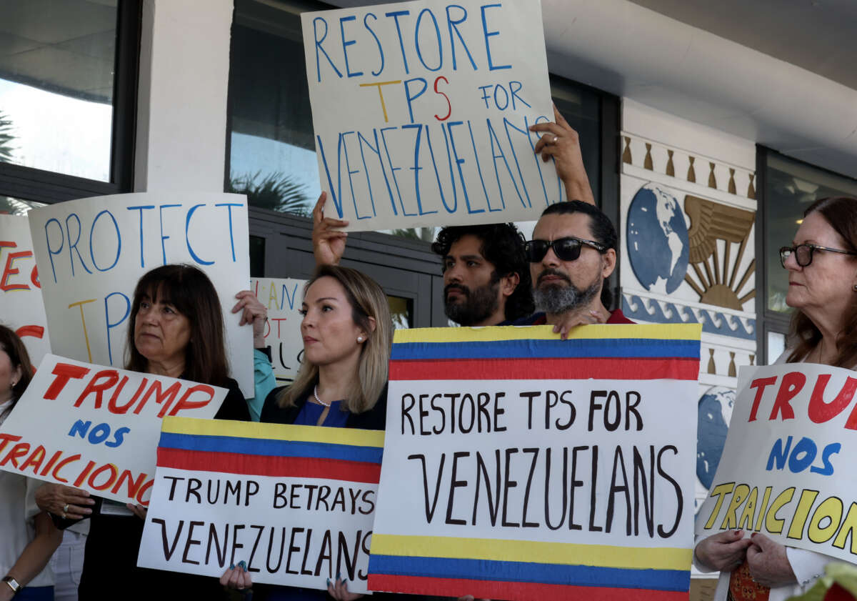 Laura Kelley, Miami-Dade County Democratic Party Chair, (2nd L) joins with others to support a resolution in favor of reinstating temporary protected status for Venezuelans on February 13, 2025, in Miami, Florida.