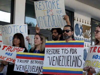 Laura Kelley, Miami-Dade County Democratic Party Chair, (2nd L) joins with others to support a resolution in favor of reinstating temporary protected status for Venezuelans on February 13, 2025, in Miami, Florida.