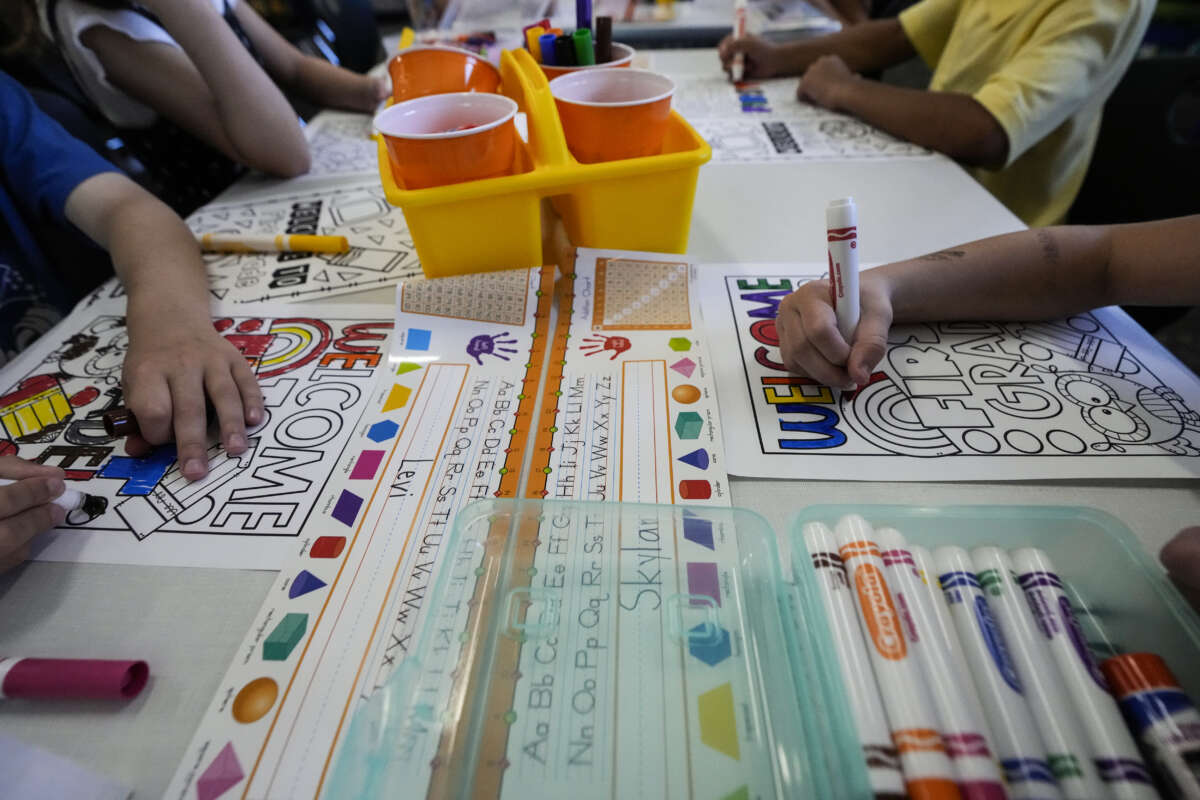 First graders color a worksheet on the first day of school at Conroe ISD's Eissler Elementary School in Conroe, Texas, on Wednesday, August 13, 2025.