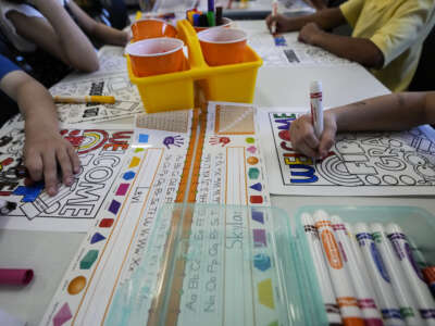 First graders color a worksheet on the first day of school at Conroe ISD's Eissler Elementary School in Conroe, Texas, on Wednesday, August 13, 2025.