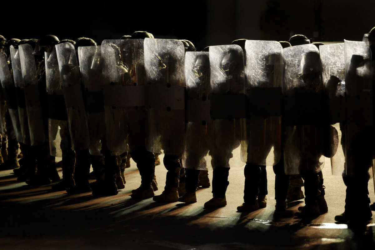 U.S. National Guard stand outside the back entrance of the Edward R. Roybal Federal Building as demonstrators gather outside the building barricades to advocate for immigrant rights on Labor Day, September 1, 2025, in Los Angeles, California.