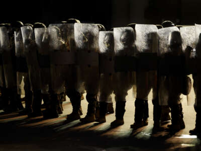 U.S. National Guard stand outside the back entrance of the Edward R. Roybal Federal Building as demonstrators gather outside the building barricades to advocate for immigrant rights on Labor Day, September 1, 2025, in Los Angeles, California.