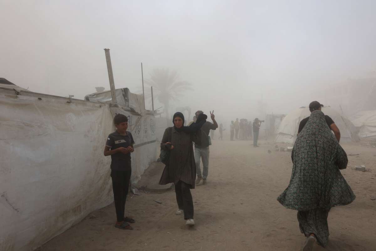 Palestinians evacuate as smoke covers the area after Israel issued evacuation orders ahead of a military strike on the Mushtaha Tower in Gaza City, on September 5, 2025.