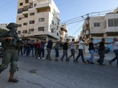 Israeli soldiers detain Palestinians during a raid following the reported explosion of an Israeli military vehicle near a checkpoint west of Tulkarem in the occupied West Bank, on September 11, 2025.