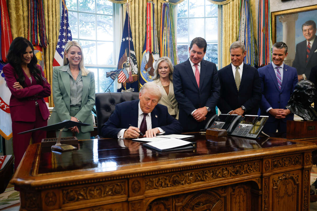 President Donald Trump signs a Presidential Memorandum in the Oval Office on September 15, 2025, in Washington, D.C.