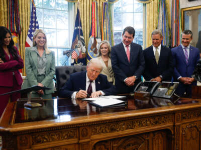 President Donald Trump signs a Presidential Memorandum in the Oval Office on September 15, 2025, in Washington, D.C.