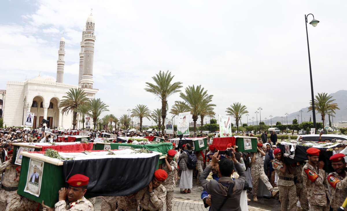 Yemeni military soldiers carry coffins during a funeral procession for Yemeni journalists killed in Israeli airstrikes, on September 16, 2025, in Sana'a, Yemen.