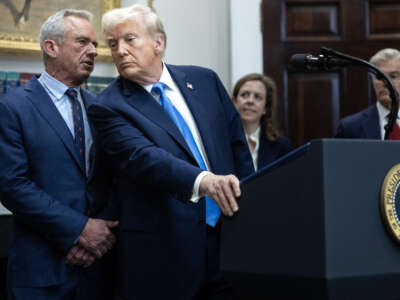 Health and Human Services Secretary Robert F. Kennedy Jr. speaks quietly to President Donald Trump during a news conference on September 22, 2025, inside the Roosevelt Room at The White House in Washington, D.C.
