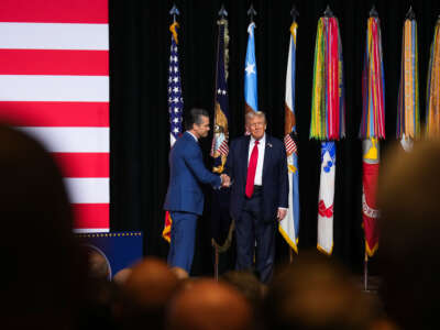 President Donald Trump greets U.S. Secretary of War Pete Hegseth as he arrives to speak to senior military leaders at Marine Corps Base Quantico on September 30, 2025, in Quantico, Virginia.