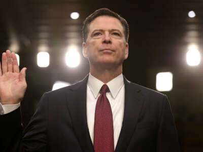 Former FBI Director James Comey is sworn in while testifying before the Senate Intelligence Committee in the Hart Senate Office Building on Capitol Hill on June 8, 2017, in Washington, D.C. Comey said that President Donald Trump pressured him to drop the FBI's investigation into former National Security Advisor Michael Flynn and demanded Comey's loyalty during the one-on-one meetings he had with the president.