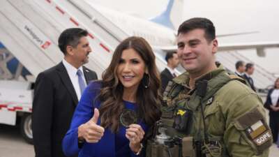 U.S. Homeland Security Secretary Kristi Noem poses for photos with a member of the Chilean special operations police (GOPE) as she departs Arturo Merino Benitez International Airport on July 30, 2025 in Santiago, Chile. Noem was on a multi-day visit to Argentina, Chile, and Paraguay.
