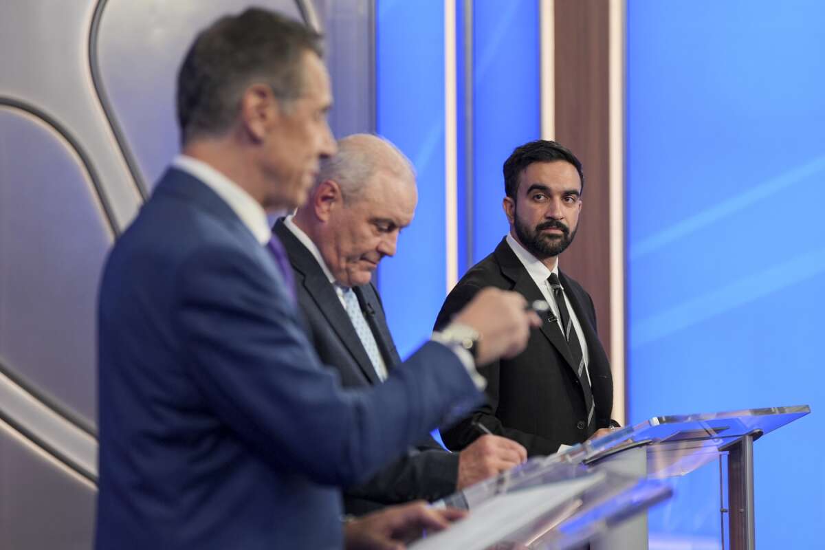 Former New York Gov. Andrew Cuomo (L), Republican nominee Curtis Sliwa, and Democratic nominee Zohran Mamdani participate in a mayoral debate at Rockefeller Center on October 16, 2025 in New York City.