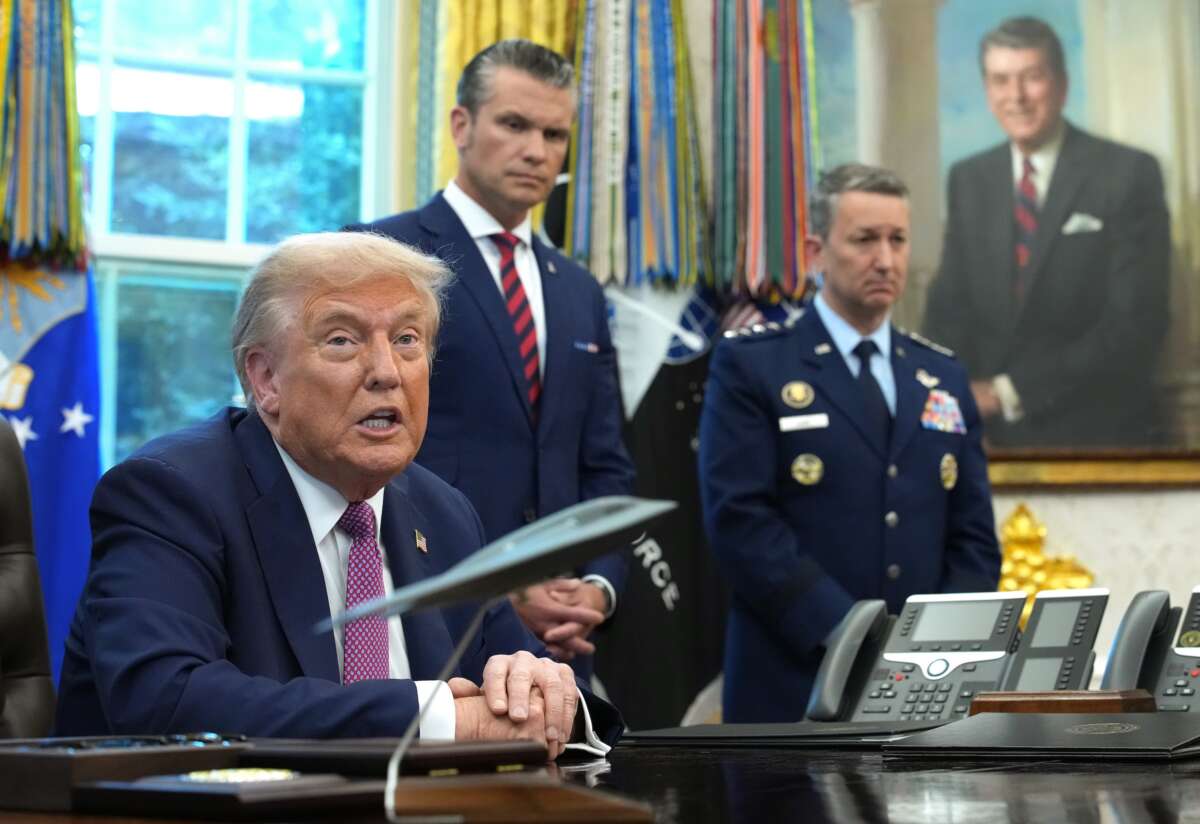 U.S. President Donald Trump speaks to be media prior to signing an executive order renaming the Department of Defense as the Department of War as U.S. Defense Secretary Pete Hegseth (C) and Chairman of the Joint Chiefs of Staff Air Force Gen. Dan Caine (R) look on on September 05, 2025 in Washington, DC.