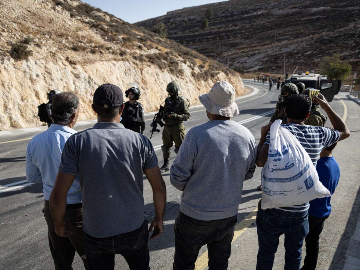 The Israeli army prevents Palestinians from reaching their lands to harvest olives after declaring the area a closed military zone on October 23, 2025, in Si'ir, Hebron.