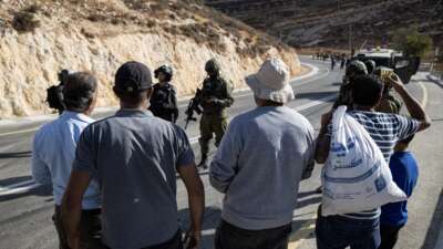 The Israeli army prevents Palestinians from reaching their lands to harvest olives after declaring the area a closed military zone on October 23, 2025, in Si'ir, Hebron.