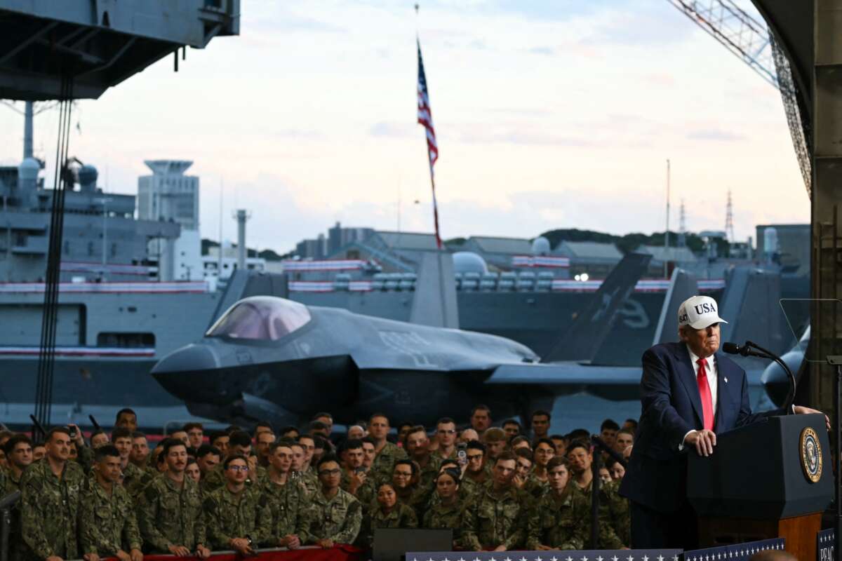 U.S. President Donald Trump delivers a speech in front of U.S. Navy personnel on board the Navy's USS George Washington aircraft carrier at the U.S. naval base in Yokosuka, Japan, on October 28, 2025.