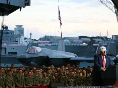 U.S. President Donald Trump delivers a speech in front of U.S. Navy personnel on board the Navy's USS George Washington aircraft carrier at the U.S. naval base in Yokosuka, Japan, on October 28, 2025.