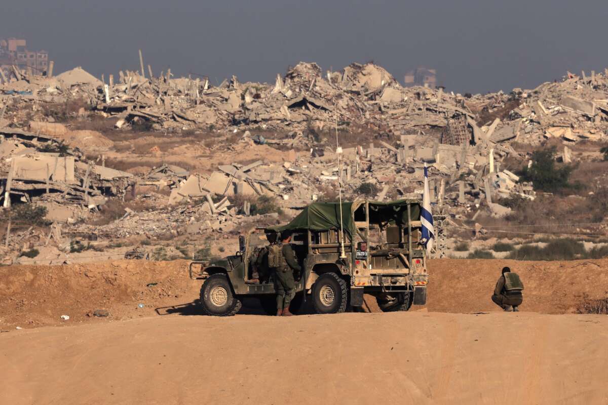Israeli soldiers take up a position near the Israel–Gaza border fence on October 30, 2025.