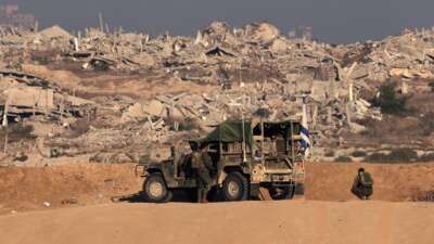 Israeli soldiers take up a position near the Israel–Gaza border fence on October 30, 2025.