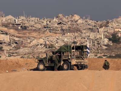 Israeli soldiers take up a position near the Israel–Gaza border fence on October 30, 2025.