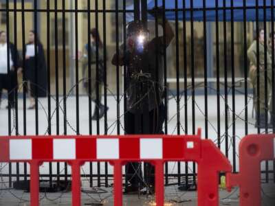 A worker welds a gate to a military court during a demonstration against Israeli military prosecutors on July 30, 2024 in Kfar Yona, Israel. The prior day, far-right protesters broke into the Sde Teiman compound to show support for Israeli reservists detained over allegations of abusing a Palestinian detainee.