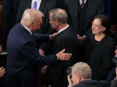 President Donald Trump greets Chief Supreme Court Justice John Roberts as he arrives to deliver an address to a joint session of Congress at the U.S. Capitol on March 4, 2025, in Washington, D.C.