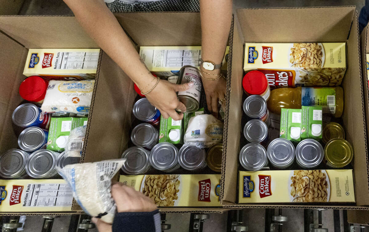 Workers pack boxes for the Commodity Supplemental Food Program at The Orange County Food Bank in Garden Grove, California, on May 9, 2025.