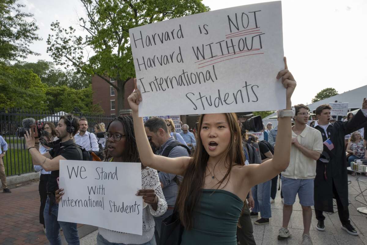 People hold up signs during the Harvard Students for Freedom rally in support of international students at the Harvard University campus in Boston, Massachusetts, on May 27, 2025. Harvard students protested after the U.S. government said it intends to cancel all remaining financial contracts with the university, President Donald Trump's latest attempt to force the prestigious institution to submit to unprecedented oversight.