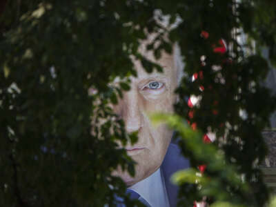 A banner showing a picture of President Donald Trump is displayed outside of the U.S. Department of Agriculture building and seen through trees on the National Mall on June 3, 2025, in Washington, D.C.