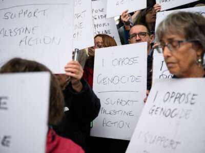 Supporters of Palestine Action hold placards before being arrested in Parliament Square after holding a small demonstration on July 19, 2025, in London, England.