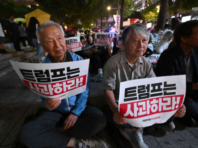 South Korean protesters hold signs reading "Trump, apologize!" during an anti-U.S. rally against detention of South Korean workers after a U.S. immigration raid in Georgia, near the U.S. embassy in Seoul, South Korea, on September 12, 2025.