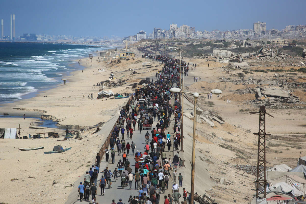 Palestinians make their way along Al-Rashid road toward Gaza City from Nuseirat in the central Gaza Strip, on October 10, 2025.